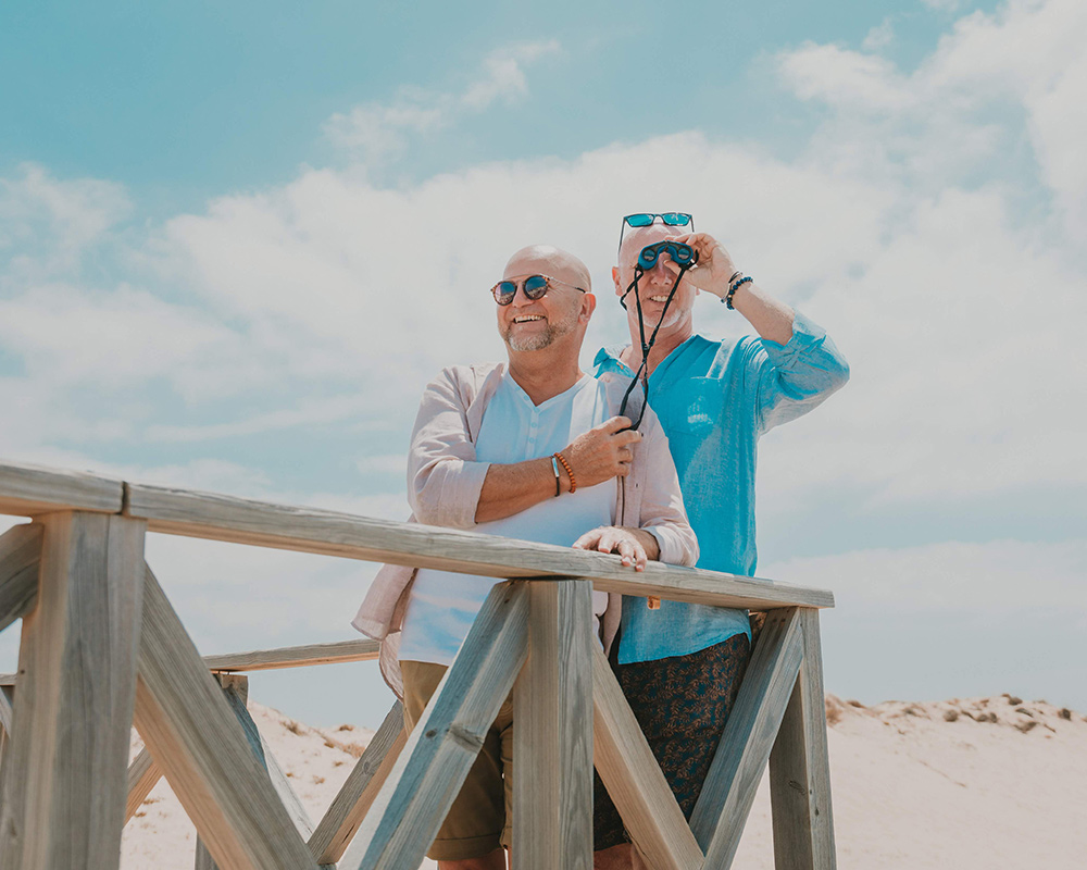 Cute gay older couple looking around near the beach at Quinta do Lago, Algarve, Portugal