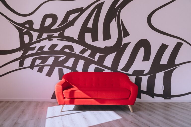 Breakthrough mural with red sofa at KOBU Agency, Faro, Portugal
