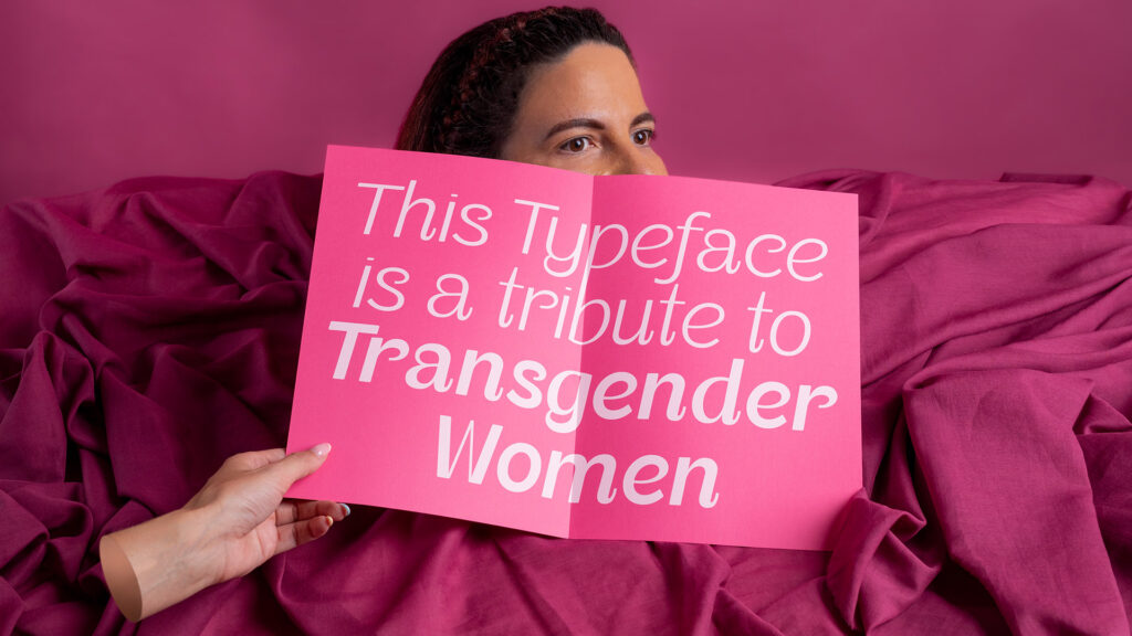 Hand holding paper saying "This Typeface is a tribute to transgender woman"