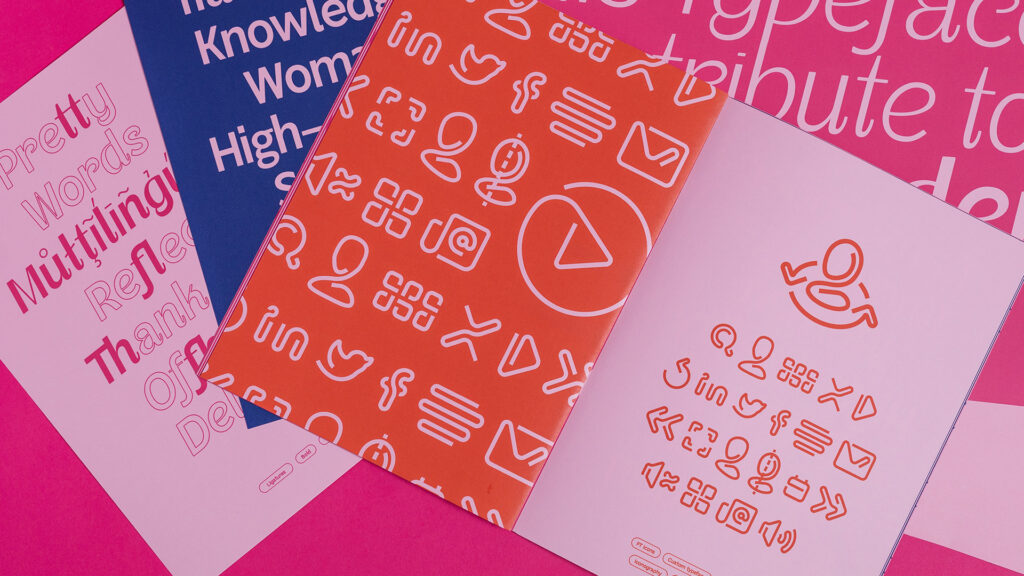 Sheets of pink, blue and orange papers with Facialteam's custom typefaces designed by KOBU Agency
