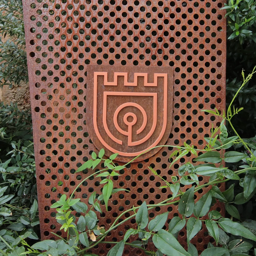 Rust-colored metal sign with Ombria signage