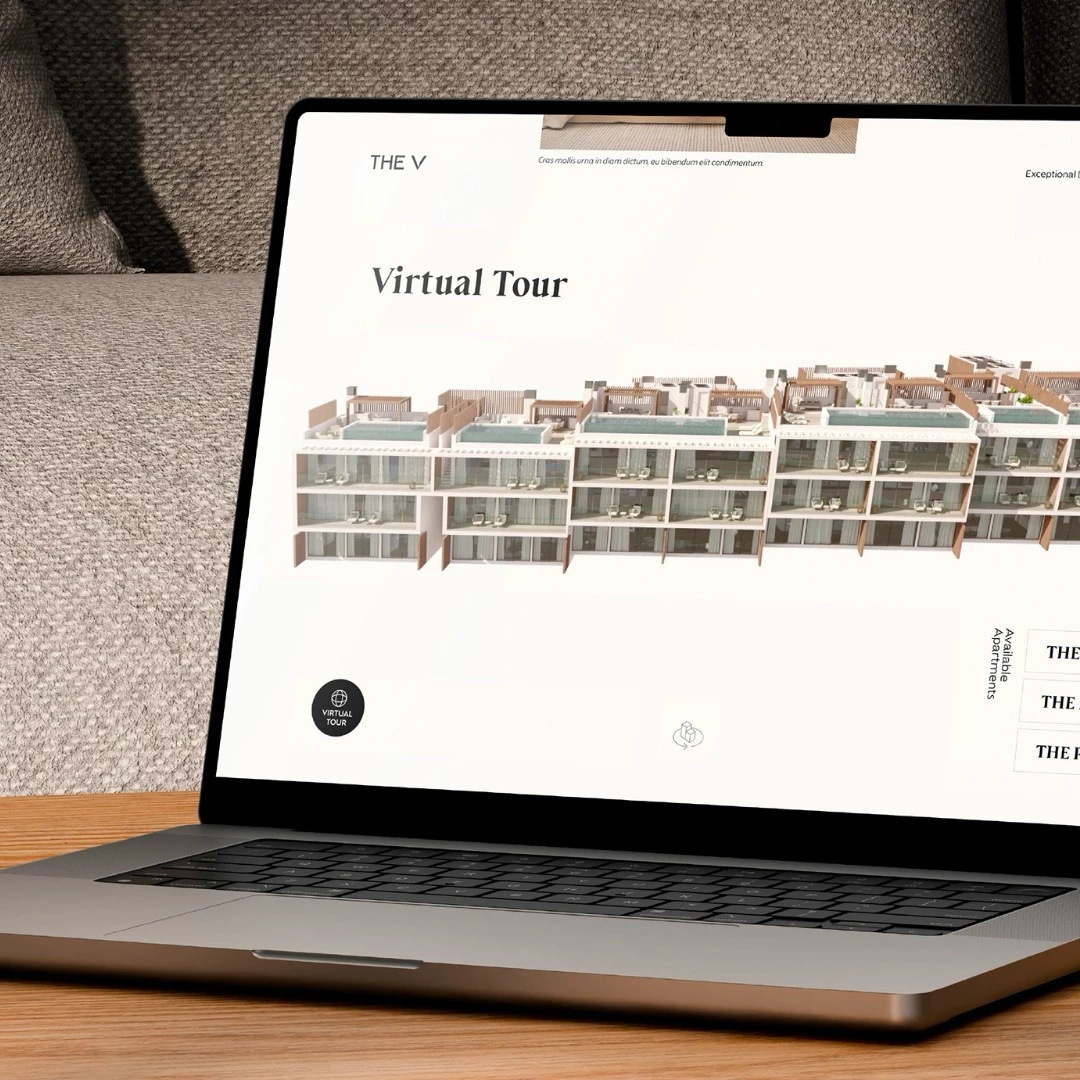 Laptop displaying TheV Apartments virtual tour with 3D model of their modern residential buildings